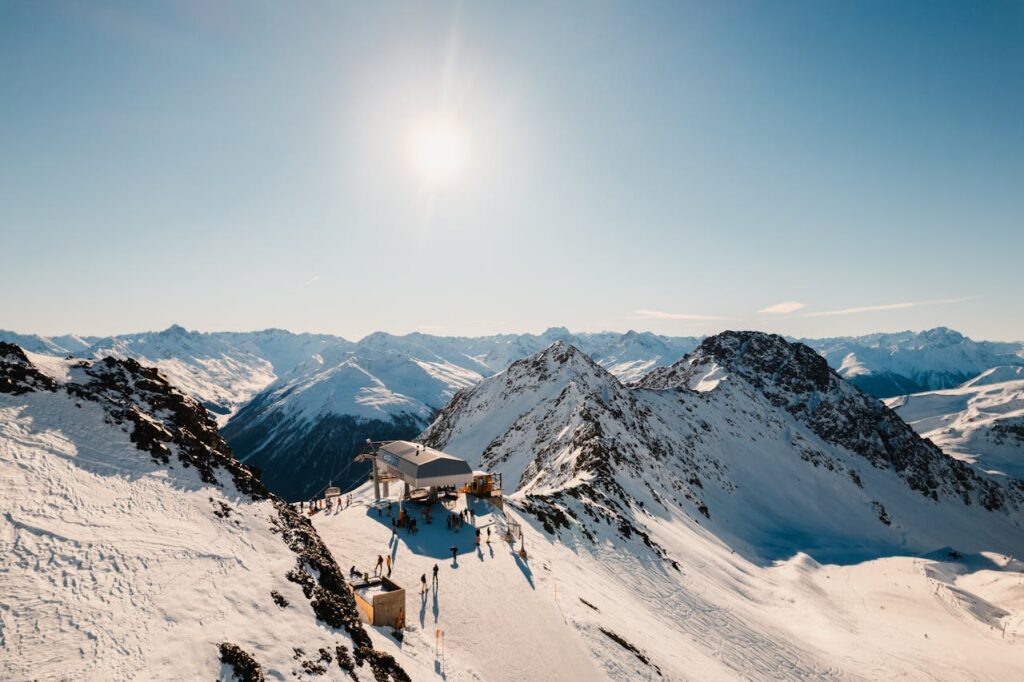 pexels-photo-10611015 Sun Shining Over Snowcapped Mountain Range and Ski Lift